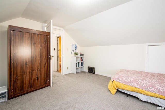 bedroom featuring carpet floors, baseboards, and vaulted ceiling