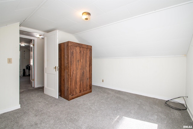 additional living space with vaulted ceiling, carpet flooring, and baseboards