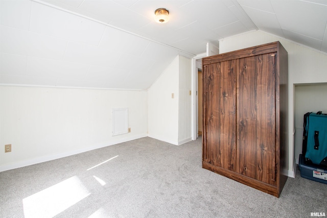 bonus room featuring lofted ceiling, carpet, and baseboards