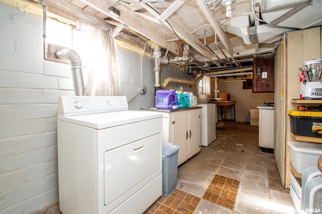 washroom with cabinet space and washer / dryer