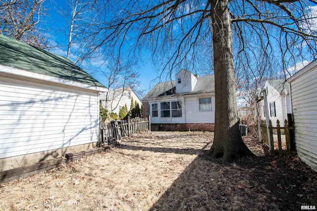 view of yard featuring central air condition unit and fence