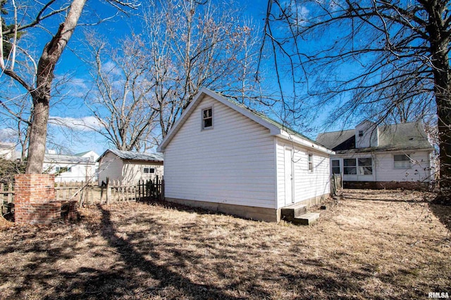 view of property exterior featuring fence