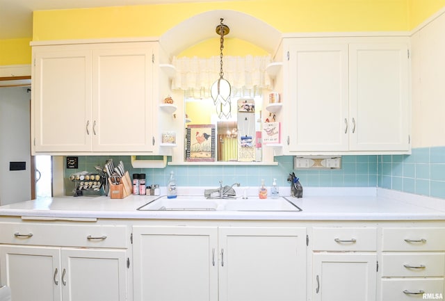 kitchen with open shelves, a sink, and white cabinetry