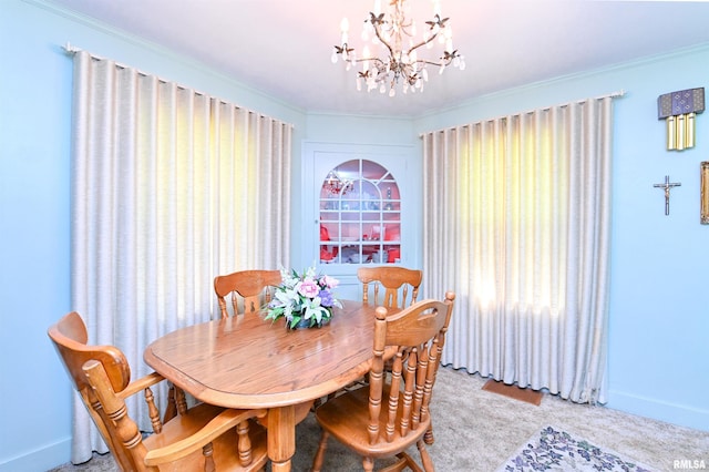 dining room with a notable chandelier, baseboards, crown molding, and light colored carpet