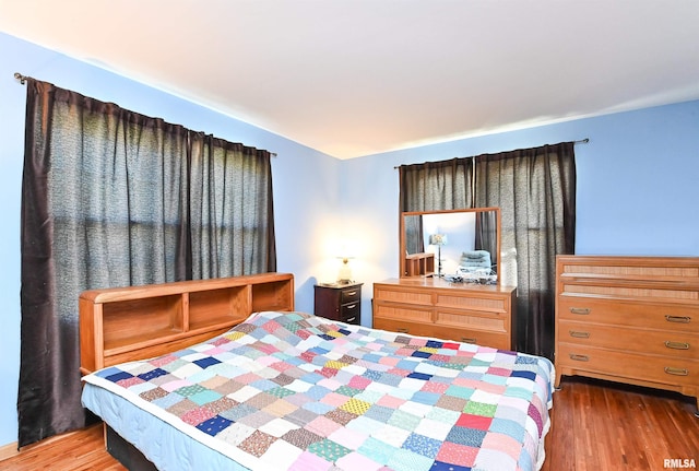 bedroom with wood finished floors