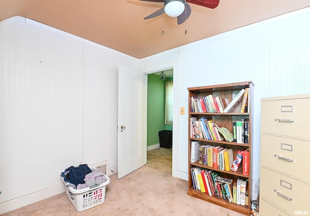 interior space with ceiling fan and carpet flooring