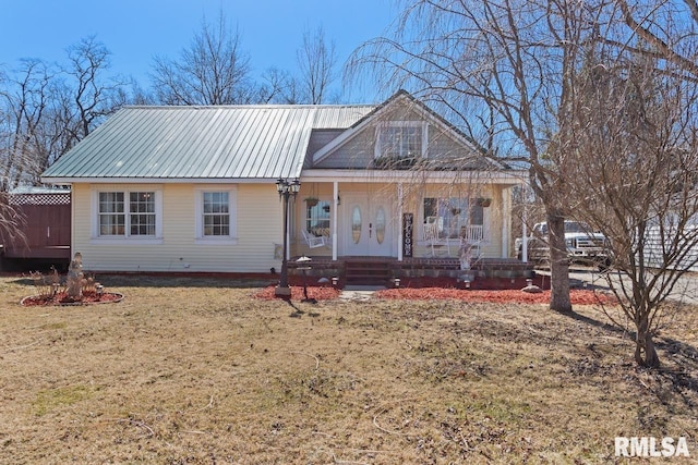 view of front facade featuring a porch, a front yard, and metal roof