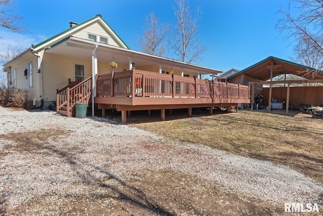 rear view of property with a wooden deck