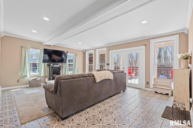 living room with beamed ceiling, a fireplace with raised hearth, french doors, crown molding, and baseboards