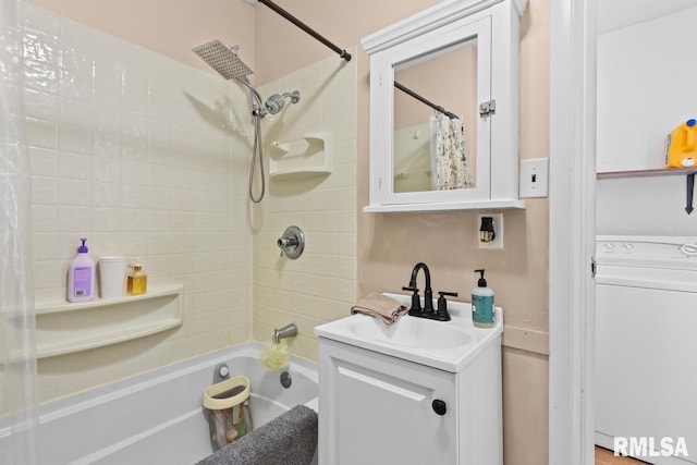 full bathroom featuring vanity, washer / clothes dryer, and shower / tub combo