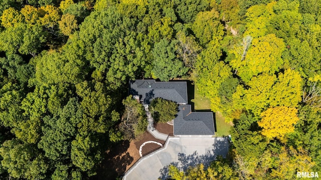 birds eye view of property with a view of trees