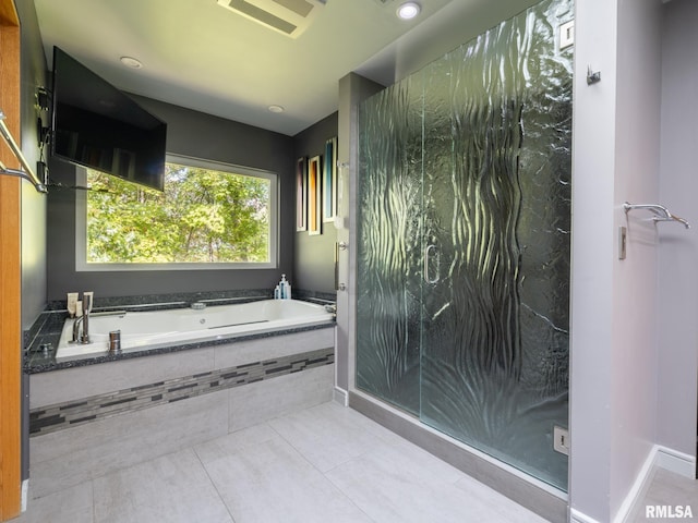 full bathroom with a stall shower, baseboards, visible vents, tile patterned floors, and a garden tub