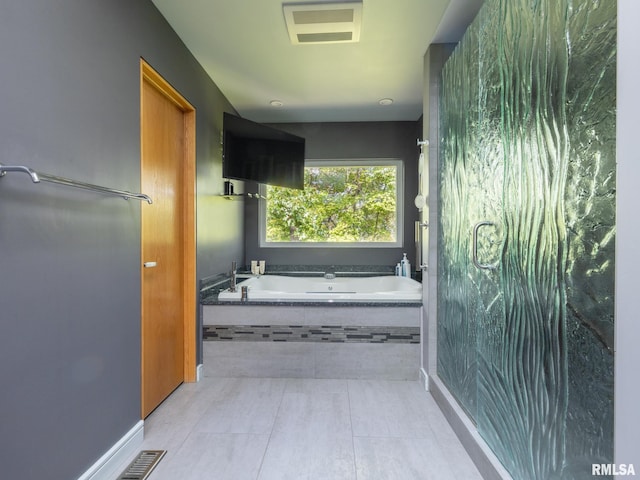 full bathroom featuring visible vents, a garden tub, and tile patterned floors