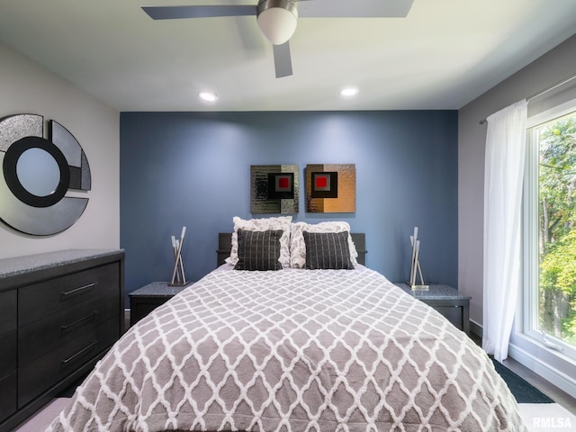 bedroom with a ceiling fan, recessed lighting, and multiple windows