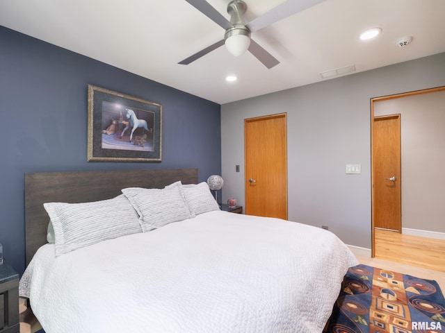 bedroom with ceiling fan, recessed lighting, wood finished floors, and baseboards