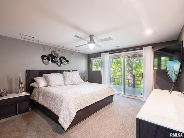 bedroom with a ceiling fan, access to outside, light carpet, and visible vents