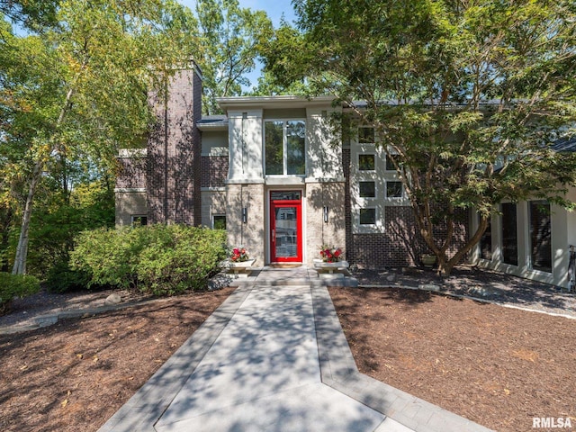 view of front of home with brick siding and stucco siding