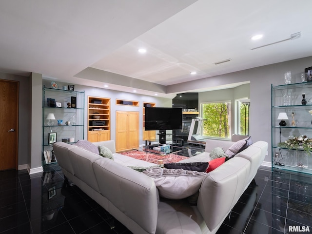 tiled living area with built in shelves, baseboards, and recessed lighting