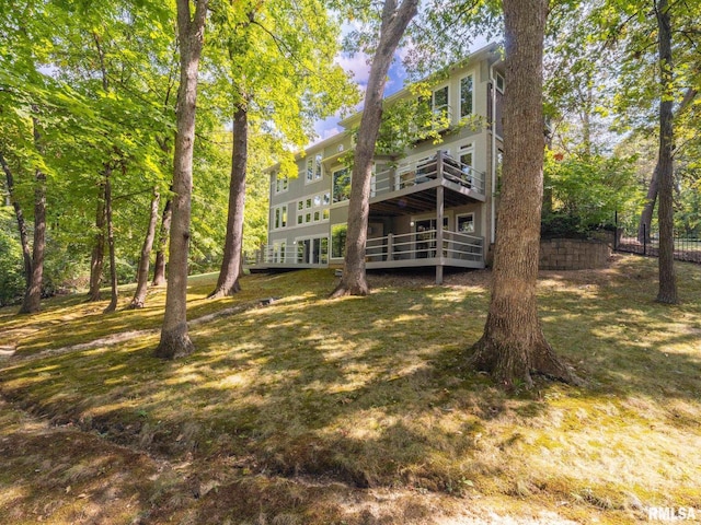 rear view of property featuring a deck and fence