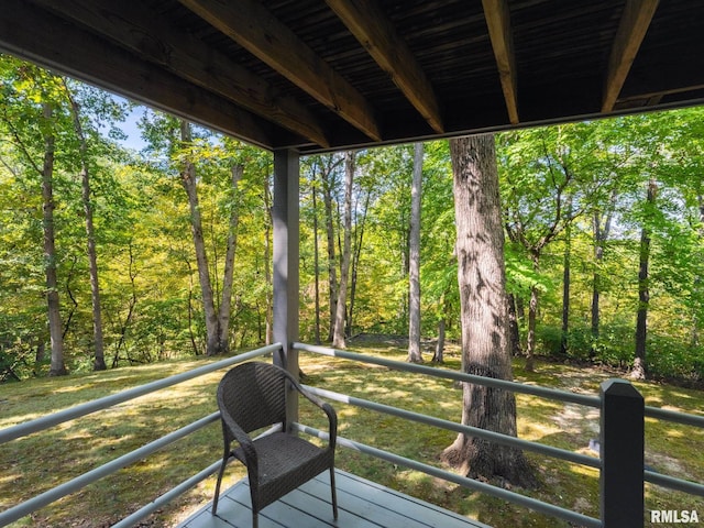 unfurnished sunroom with a wooded view