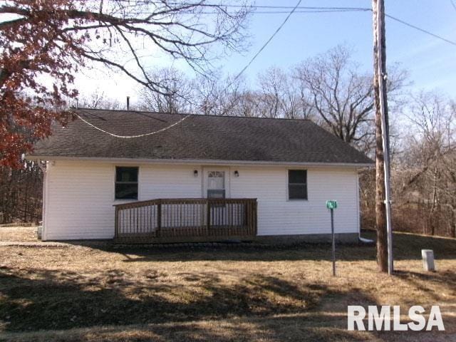 rear view of house featuring a deck