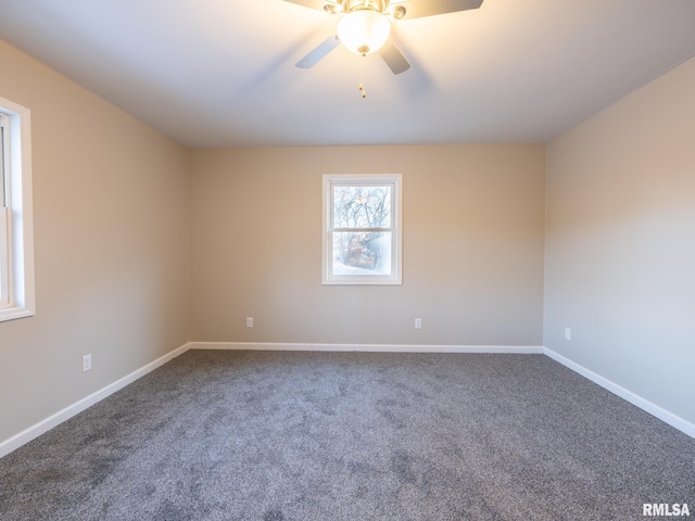 carpeted empty room with a ceiling fan and baseboards