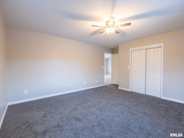 unfurnished bedroom featuring baseboards, dark carpet, ceiling fan, and a closet