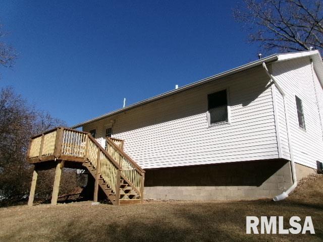 view of side of home featuring stairs and a wooden deck