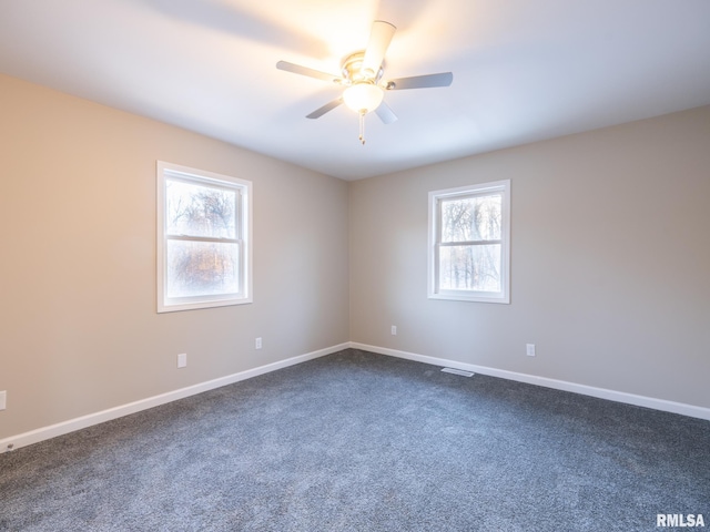 spare room with plenty of natural light, baseboards, and a ceiling fan