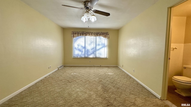 carpeted empty room featuring ceiling fan and baseboards