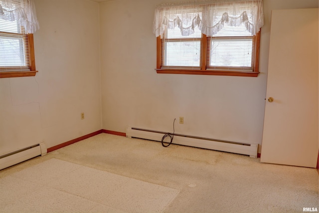 unfurnished room with baseboard heating, carpet, and baseboards