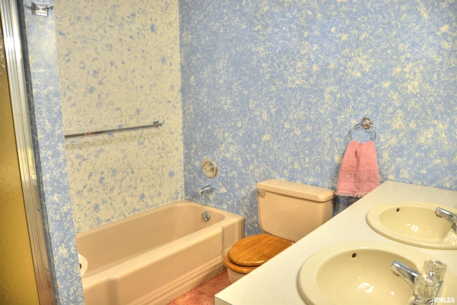 bathroom with toilet, wallpapered walls, a bath, and vanity