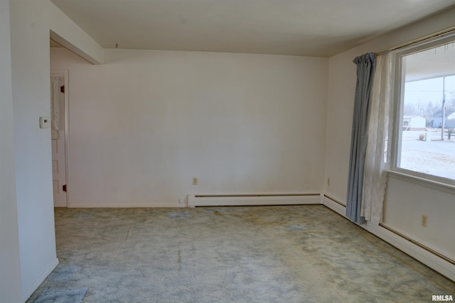 empty room with a baseboard radiator and carpet