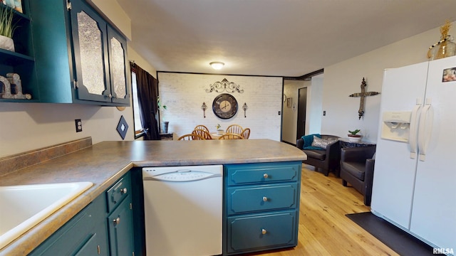 kitchen with white appliances, light wood-style floors, a peninsula, blue cabinetry, and open shelves