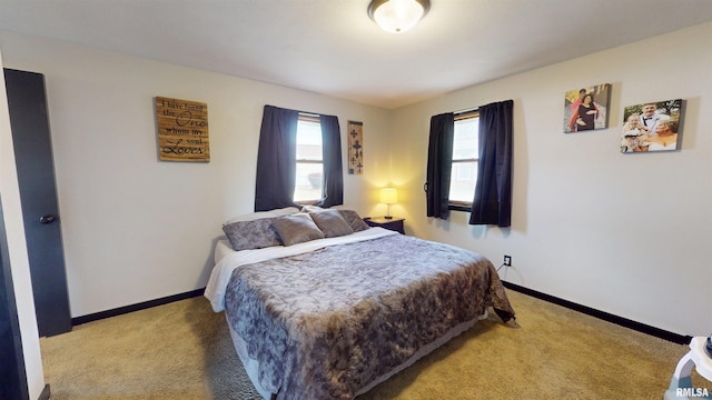 carpeted bedroom featuring baseboards