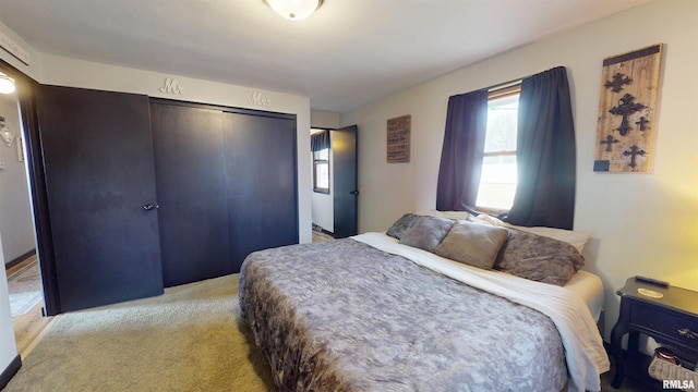 bedroom with a closet and light colored carpet