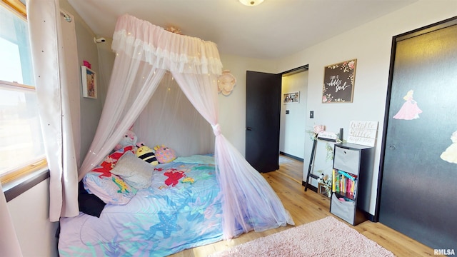 bedroom featuring a closet and wood finished floors