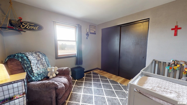 bedroom with a closet, baseboards, and wood finished floors