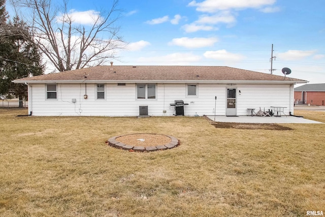 rear view of house with central AC unit, a lawn, and a patio