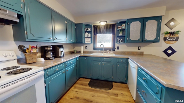 kitchen with under cabinet range hood, white appliances, a sink, light wood-type flooring, and open shelves