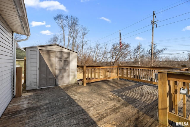 wooden deck with an outbuilding and a shed