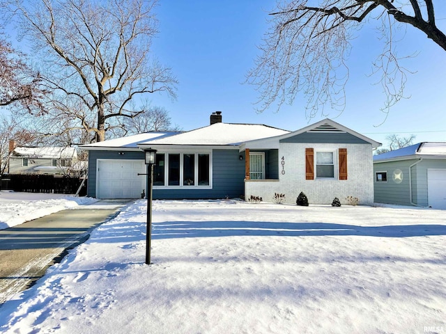 single story home featuring a garage and a chimney