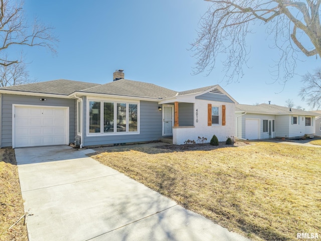 view of front of home with roof with shingles, a chimney, concrete driveway, a front yard, and a garage