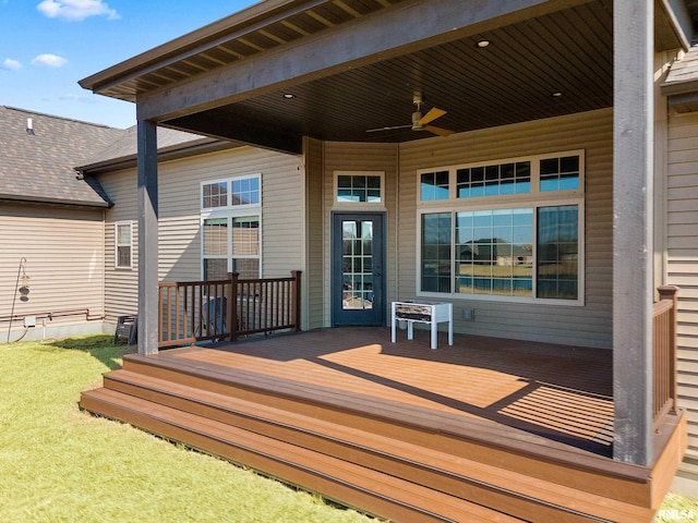 wooden deck featuring ceiling fan