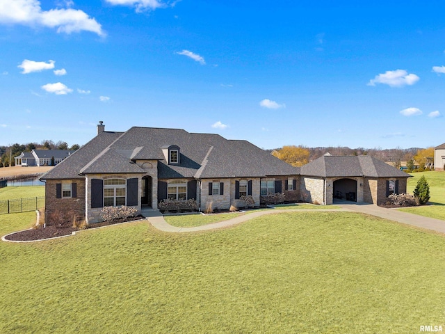 french country inspired facade featuring concrete driveway, a front yard, and fence