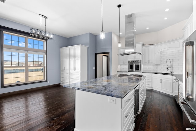 kitchen featuring stainless steel appliances, island exhaust hood, a sink, and dark wood-style floors