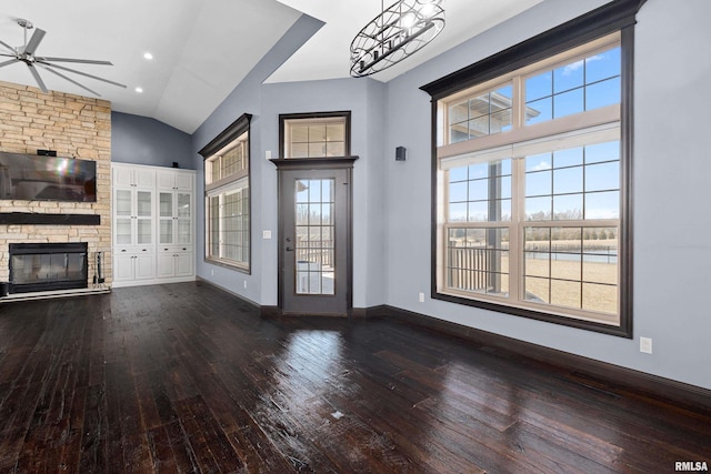 unfurnished living room featuring wood-type flooring, a fireplace, ceiling fan, and a healthy amount of sunlight