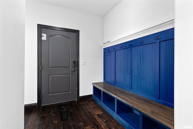 mudroom featuring baseboards and dark wood-style flooring