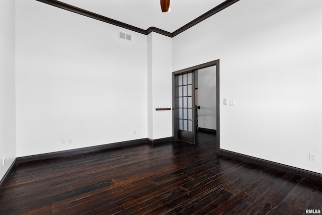 spare room featuring wood-type flooring, baseboards, ornamental molding, and visible vents