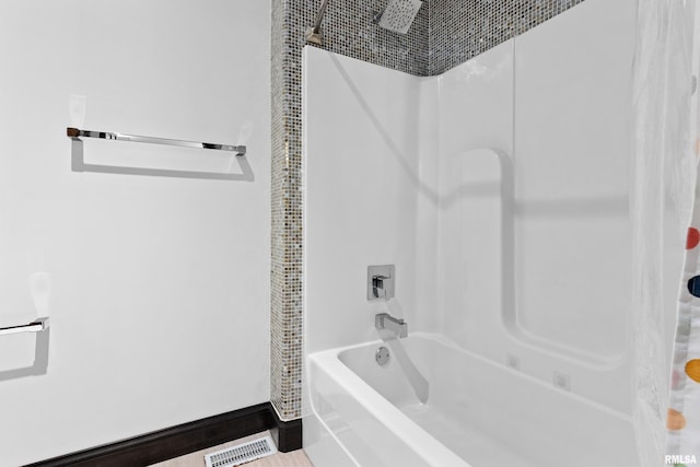 bathroom with visible vents and shower / bath combo